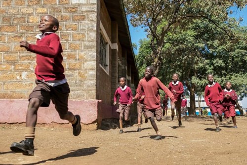Deaf children running in the school playground