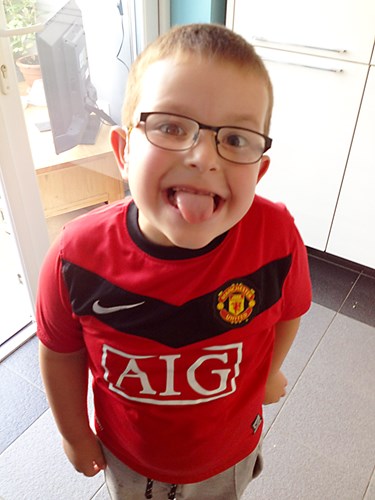 Deaf child sticking his tongue out