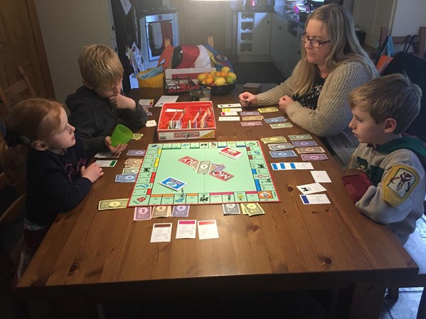 Family playing a board games