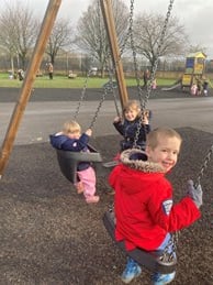 Siblings on swings