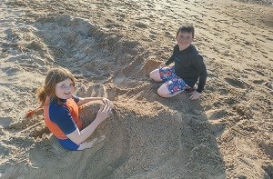 Bodhi (11) and his sister playing in the sand at a beach