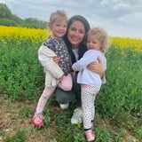 Mum Emma with her daughters Robin (4) and Eve (3) in a flower field