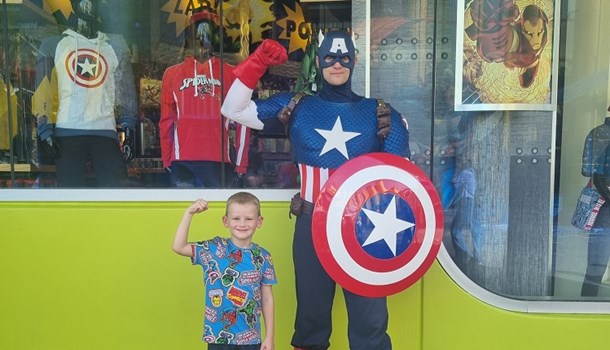 Kenzie (5) posing with Captain America