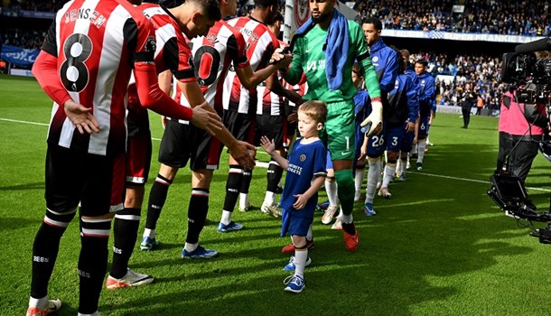 William (5) high-fiving players at the Stamford Bridge Chelsea Football Club game