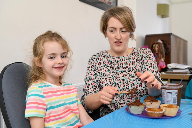 A mother and her child enjoying some baking