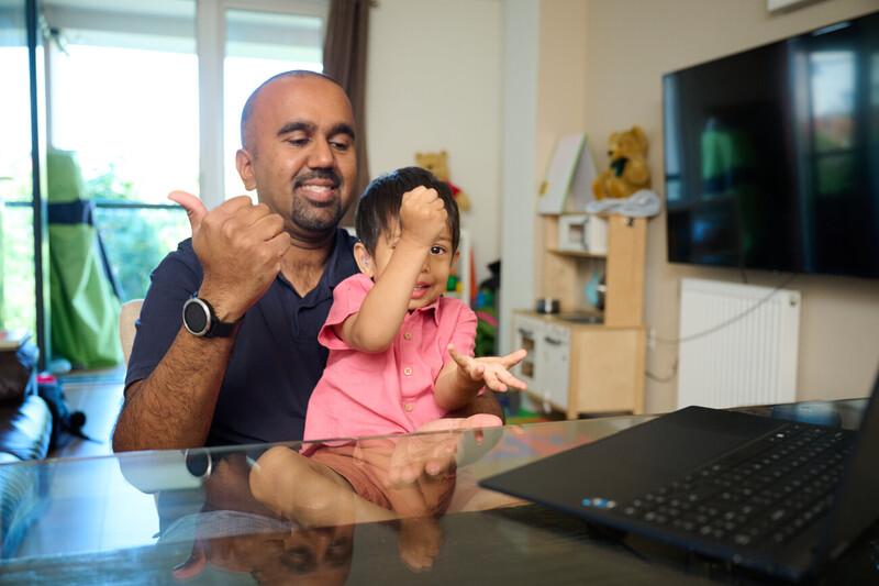 A dad and his daughter signing together 