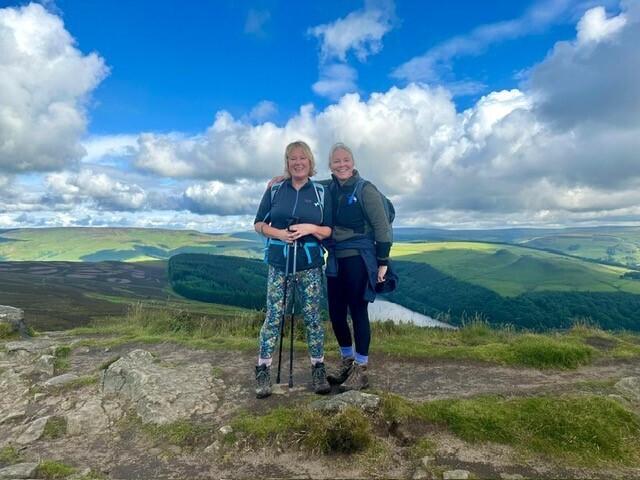 A couple of smiling hikers on a mountain