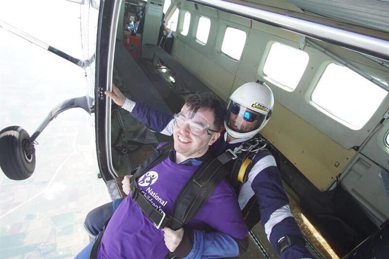 Two people jumping out of a plane skydiving
