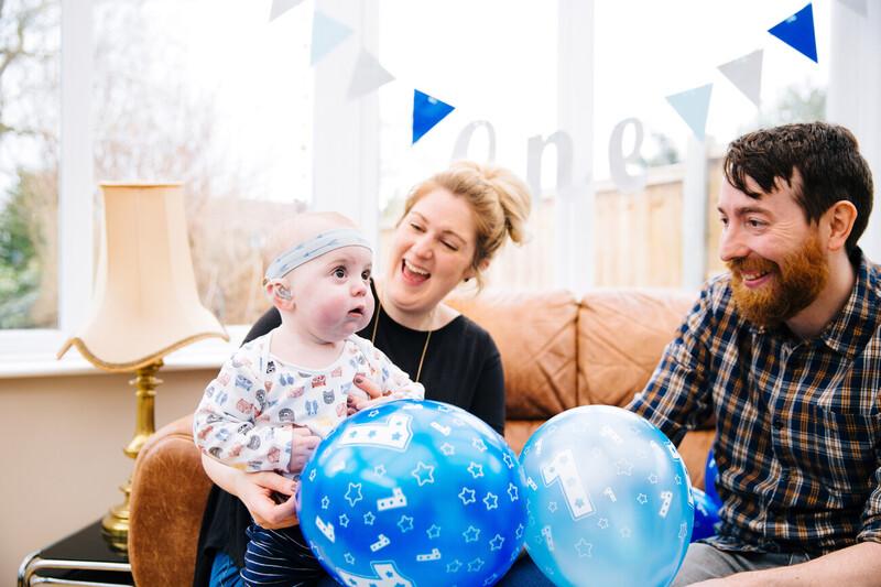 Two parents celebrating their toddlers birthday together