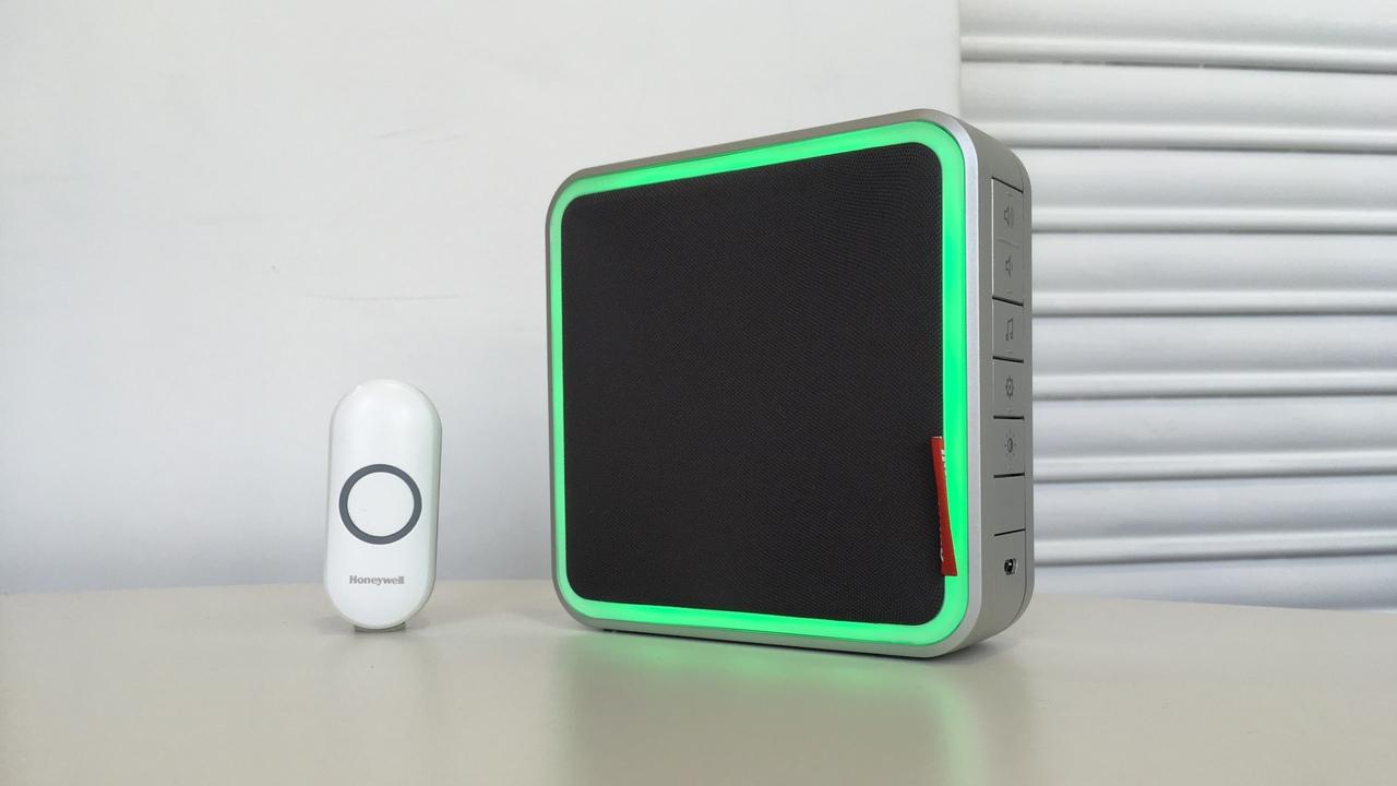 A push button next to a light-up doorbell