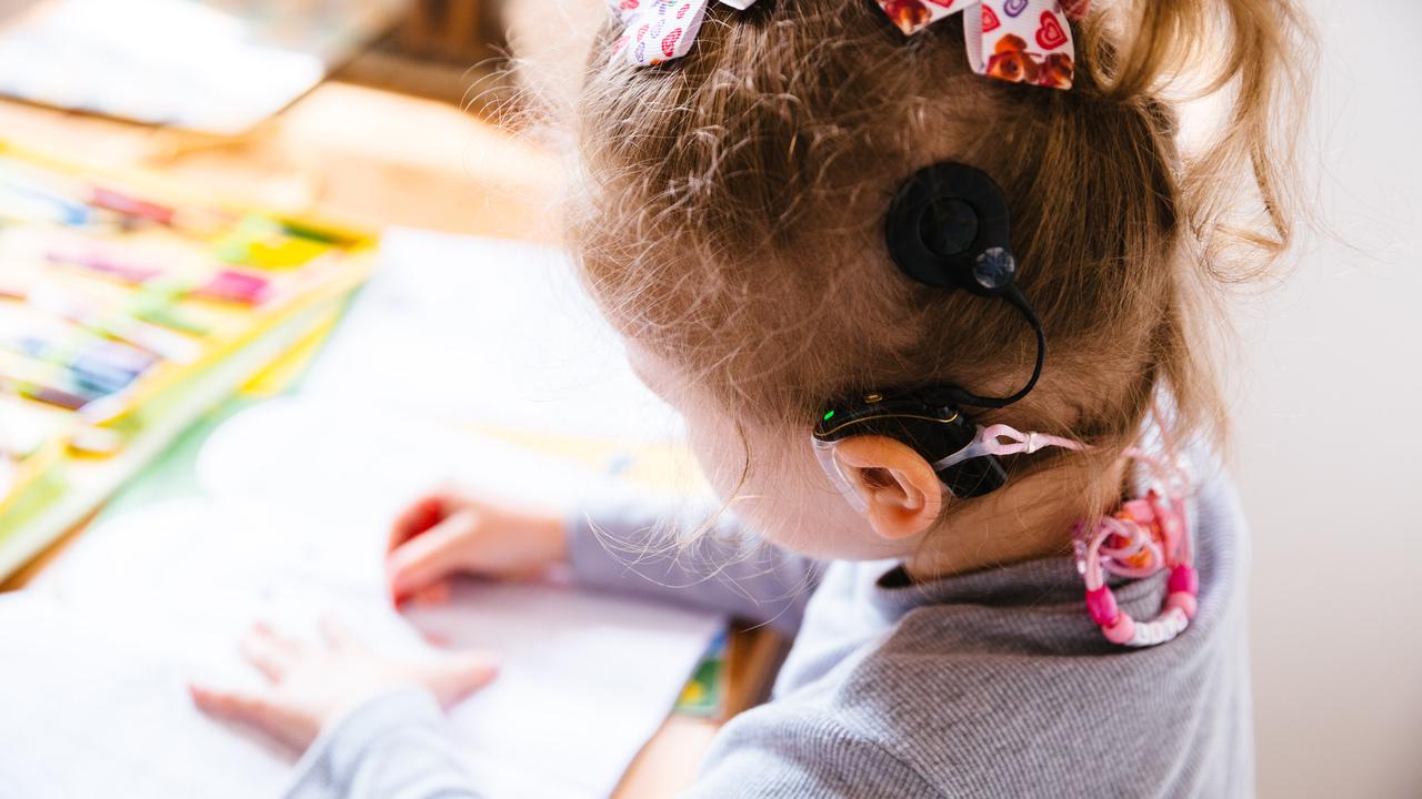 Young girl wearing a cochlear implant