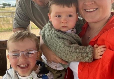Mum, Louise, holding baby George on the right of his half brother, Theo.