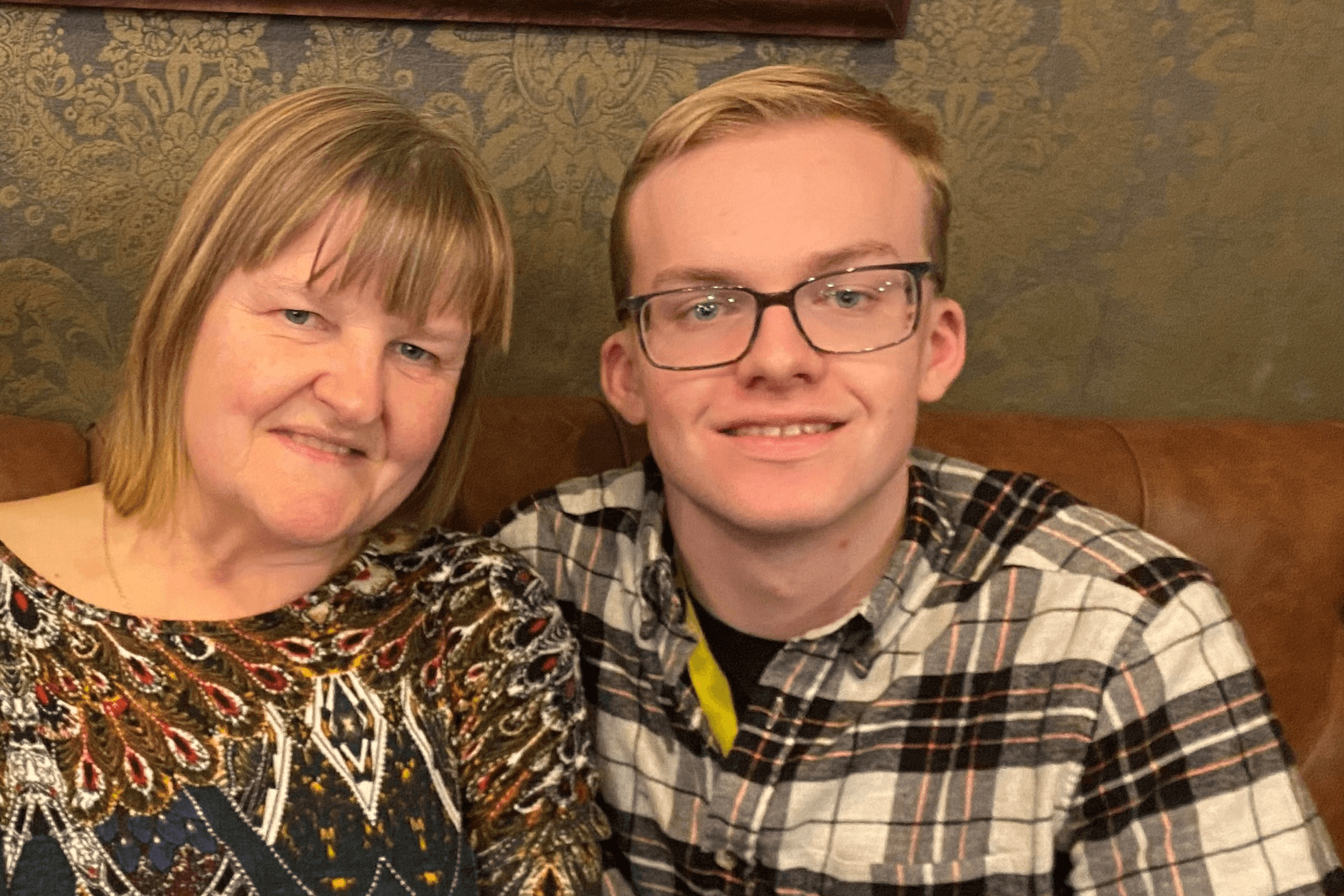 Mum Ann sitting next to her young adult son, Dan