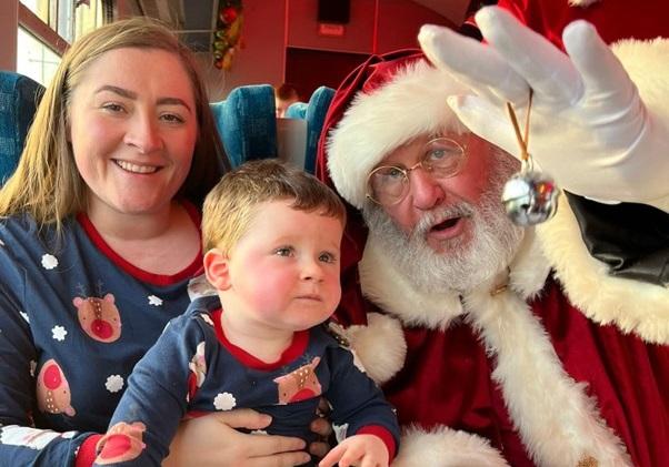 George and mum, Louise, sat with father Christmas on the Polar Express.