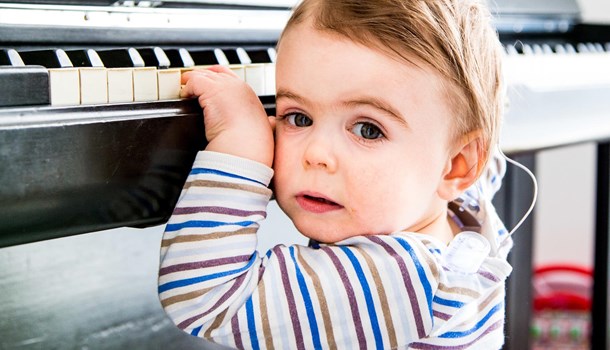 Deaf toddler with two hands on the piano 