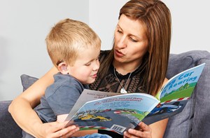 Deaf child and parent reading a book together