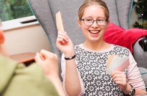 Deaf young person holding up flash cards