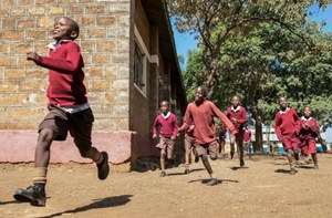 Deaf children running in school playground