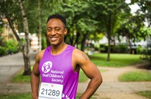 Man in purple National Deaf Children's Society running vest 