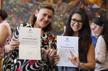 two girls holding certificate