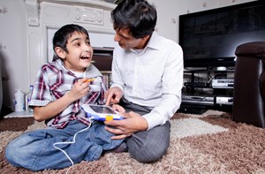 Man and young boy using a tablet