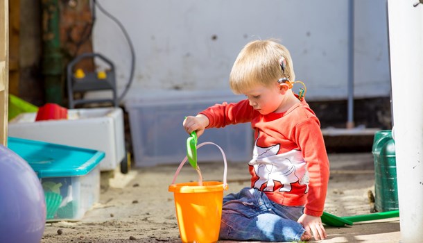 Young boy playing with a bucket and spade