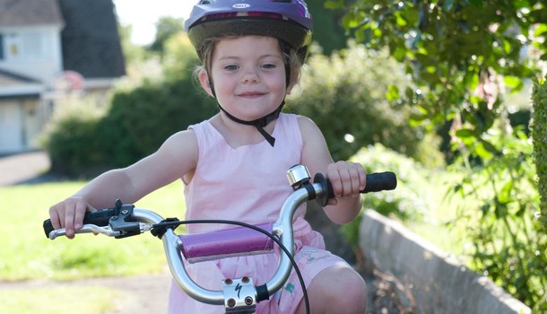 A young girl rides a bike. 
