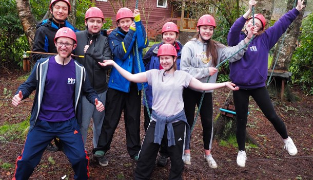 A group of young people pose at an outdoor activity centre