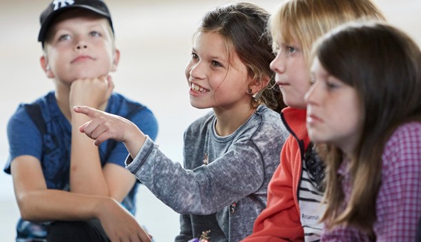 Four children sitting next to each other