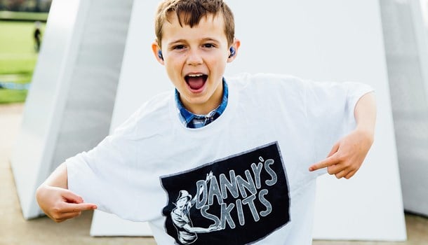 Danny showing off his T-Shirt which says 'Danny's Skits'