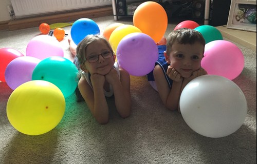 Siblings with balloons