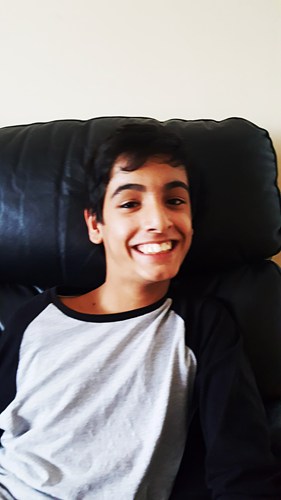 Deaf teenager sitting on a sofa