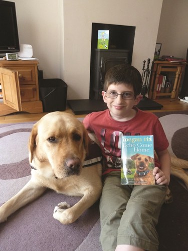 Deaf child with his dog and a book