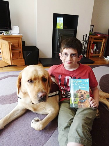Deaf child with his dog and a book