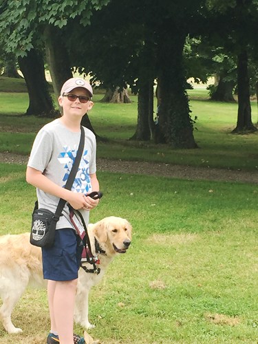 Deaf child in the park with his dog