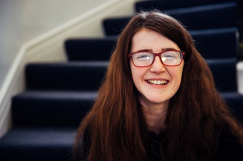 Deaf teenager sitting on the stairs