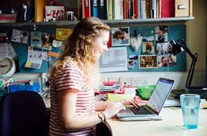 A young woman working on a laptop