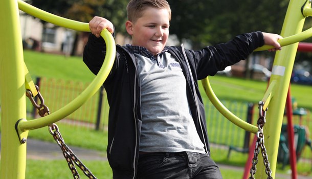 A boy plays on playground equipment. 