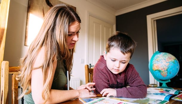 A mum looks over homework activities with her young son