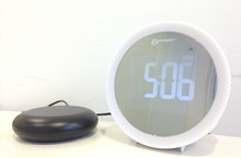 White, round Geemarc Wake 'n' Shake Star alarm clock with black vibrating pad.