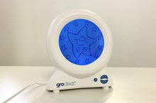 White Groclock sleep trainer with round blue screen.