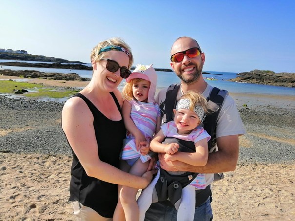 Family on the beach with two young girls