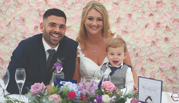 Kayleigh and Adam with their two-year-old son Henry at their wedding.