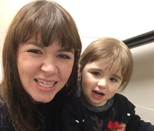 Mother and daughter smiling at camera