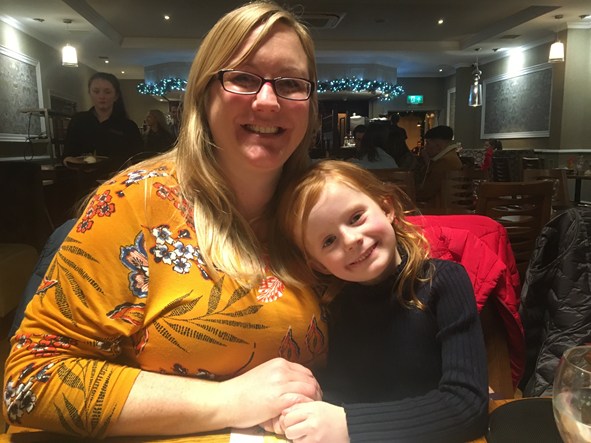 Mother and daughter sitting together in a restaurant