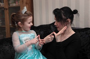 Parent and child using sign language to fingerspell