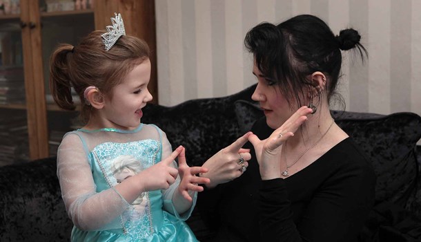 Parent and child using sign language to fingerspell 