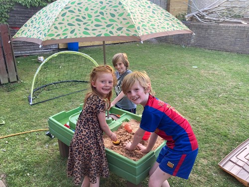 Children playing in sand table.