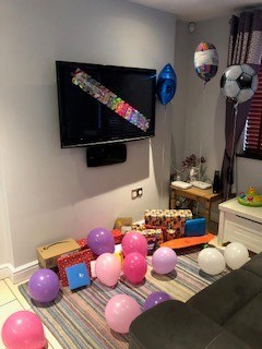 Birthday presents on the floor with balloons