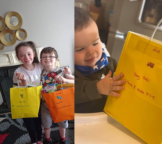 Little girl and boy on left holding colourful paper bags, baby on left holding a yellow paper bag